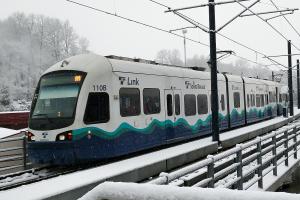 A link train approaching Mount Baker Station in the snow
