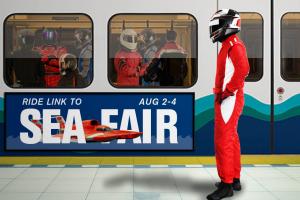 A helmeted hydroplane driver waits to board a Link light rail train where several other drivers are already on board.