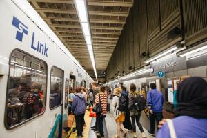 Riders board a Link light rail train at University Street Station in downtown Seattle.