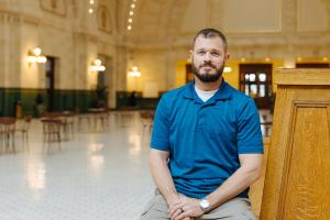 Sound Transit employee Dustin York sits on a bench inside Union Station.