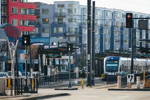 A Link train passing through Othello Station with transit oriented development in the background