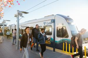 Passengers disembark a Link train.