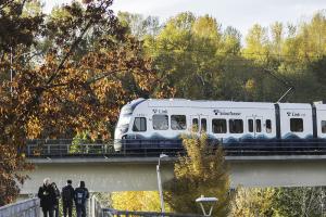 Photo of people walking on a pedestrian bridge next to Mount Baker Link Light Rail Station, West Seattle and Ballard Link Extensions