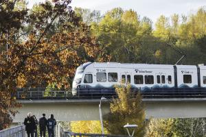 Photo of people walking on a pedestrian bridge next to Mount Baker Link Light Rail Station, West Seattle and Ballard Link Extensions