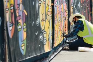 Federal Way Link Extension Dec 2020 Project update header image, Photo of a man painting a mural