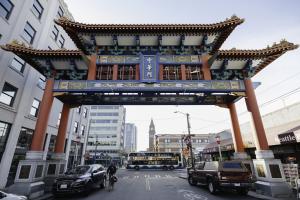 A Sound Transit Express bus passes in front of the Historic Chinatown Gate in the Chinatown-International District neighborhood in Seattle.
