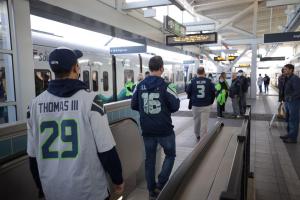 Seahawks fans board the train at Northgate Station.