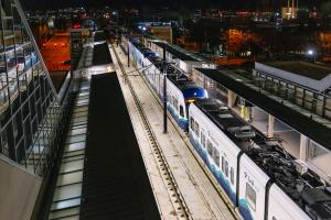 A Link train pulls into the Downtown Bellevue station at night.