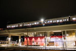 A Link train runs on elevated guideway at night in Bellevue.