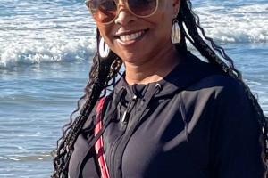 LaTonya Kadar wears sunglasses at the beach on a sunny day.