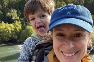 Jamie Brinkley carries a child in a backpack while hiking.