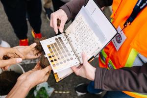 A soil color chart is used to compare different wetland soils.