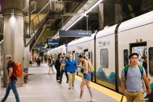 Passengers get on and off the train at Roosevelt Station. 