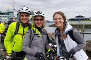 Denis Martynowych, wife Diane and daughter Anika ride their bikes to a ferry.