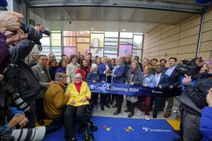 Electeds and Sound Transit officials cut the ribbon for the 2-Line opening as the public looks on