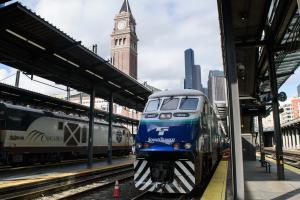 A Sounder train in the foreground with an Amtrak train in the background at King Street Station in Seattle