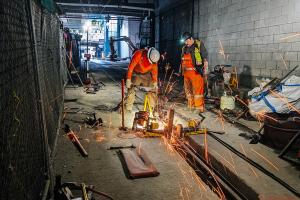 Workers grind a thermite weld on replaced rail in the Downtown Seattle Transit Tunnel on April 21, 2025, near the end of the service disruption.