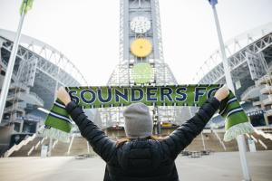 Person holding Sounders FC scarf