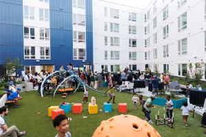 A large group of people in the interior open area of a mixed-use development