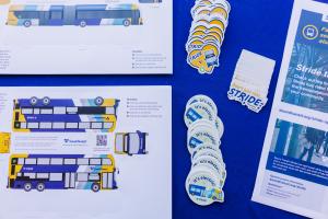 Stride bus stickers and fact sheets on a blue tablecloth