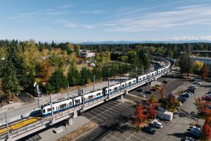 An aerial shot of a four-car train on the elevated tracks heading to Federal Way