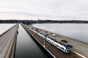 A Link light rail train travels across the I-90 Bridge.