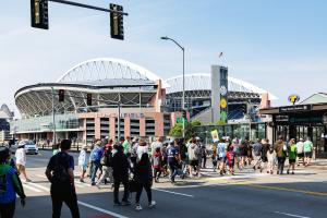 Soccer fans cross a street on their way to the stadium in downtown Seattle