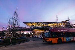 A King County bus in front of Tukwila International Boulevard Station at dusk