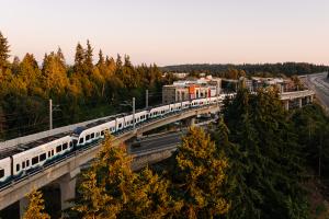 An aerial view of a Link train going south from Mountlake Terrace Station on elevated tracks