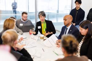 Sound Transit employees and board members sit around a table and discuss the Enterprise Initiative