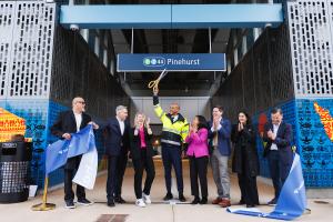 A group of board members, electeds and Sound Transit staff cut the Pinehurst ribbon