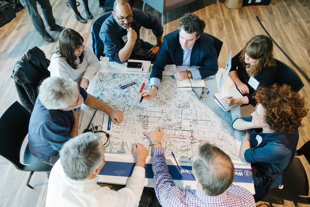 Residents and outreach staff review the West Seattle and Ballard Link Extension map.