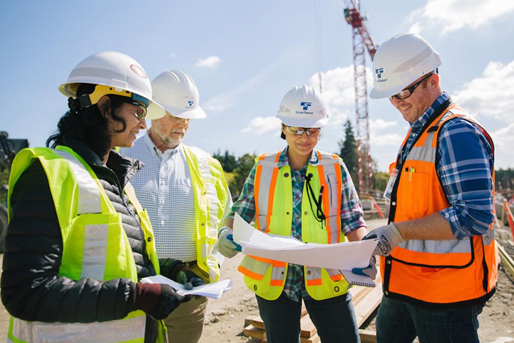 Lynnwood Link Extension construction team reviewing plans