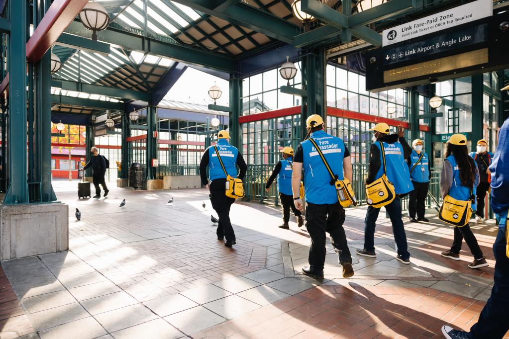 A team of four fare ambassadors walks near International District Station.