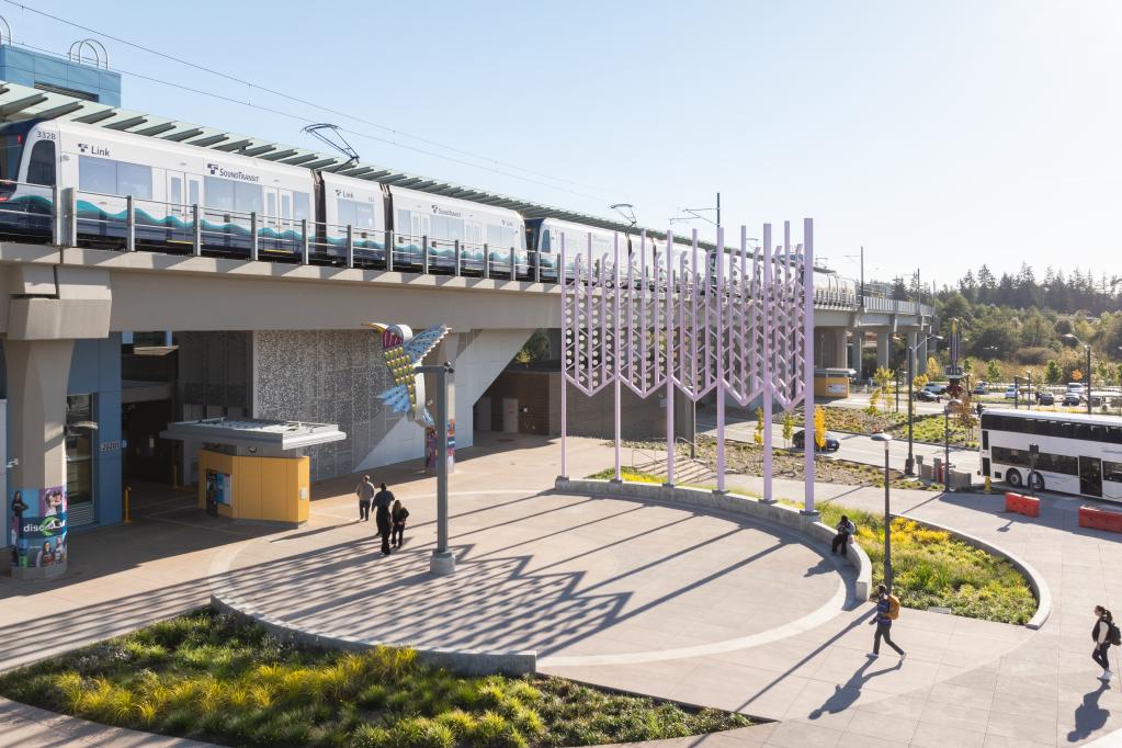 A photo of a train coming into a light rail station.