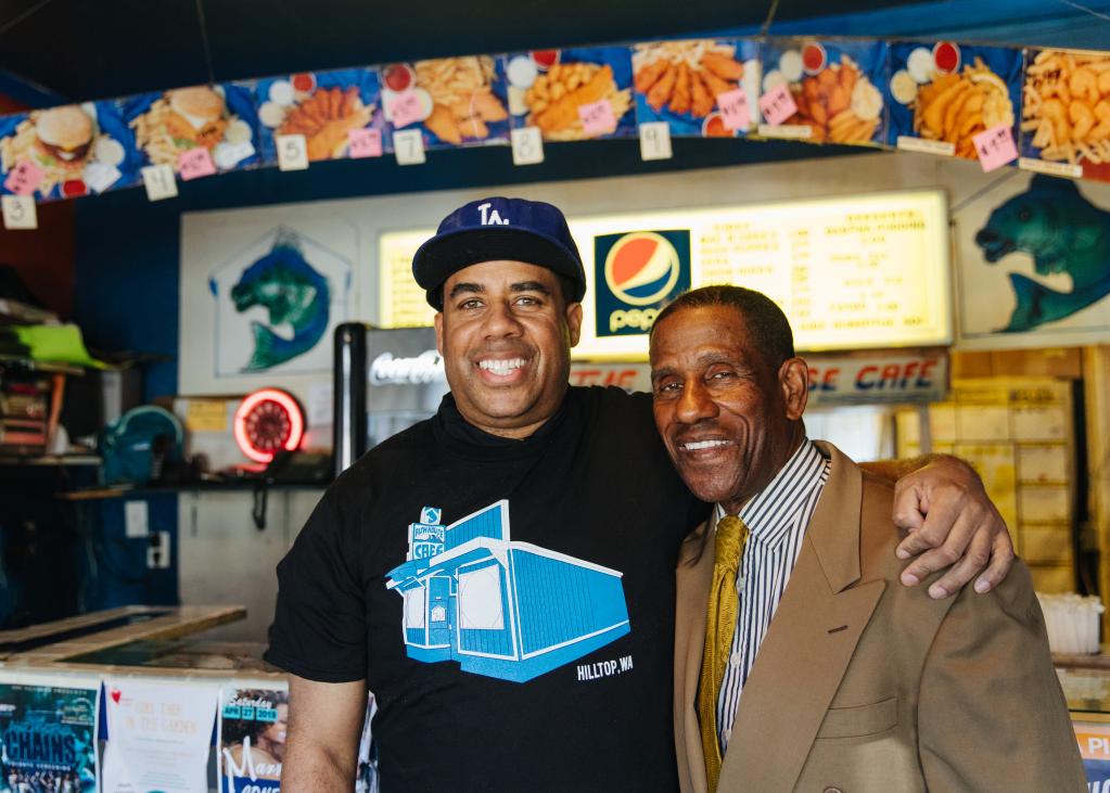 Fish House Cafe owners embrace in front of the counter