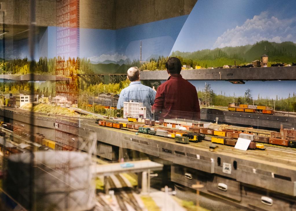 Two people look at a model train display at a museum in Tacoma