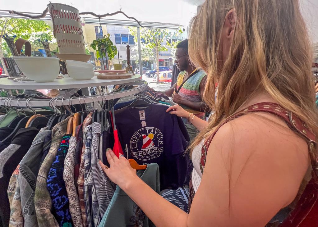 Photo of someone thrifting clothes