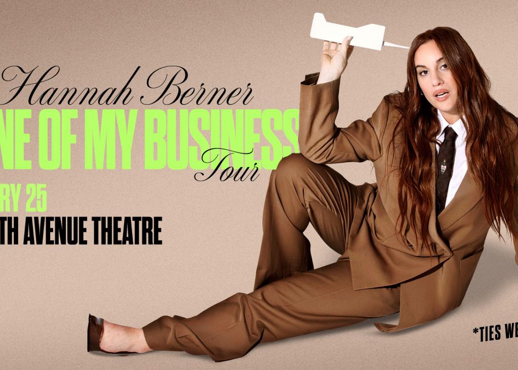 Hannah berner lays down in a suit promoting her new comedy tour