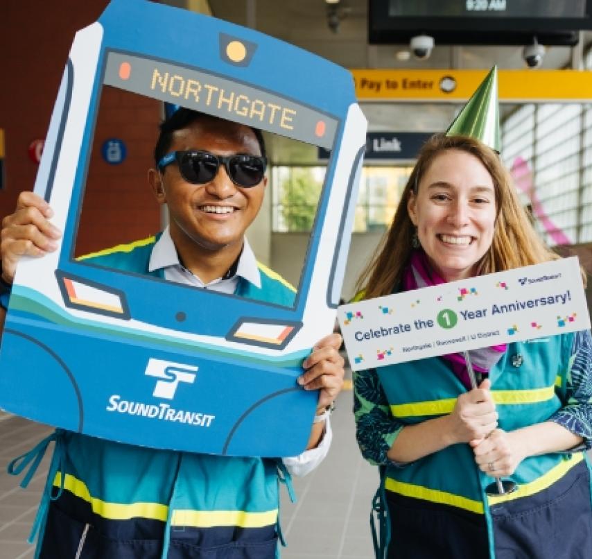 Two Sound Transit employees at an event for the Northgate Link extension.