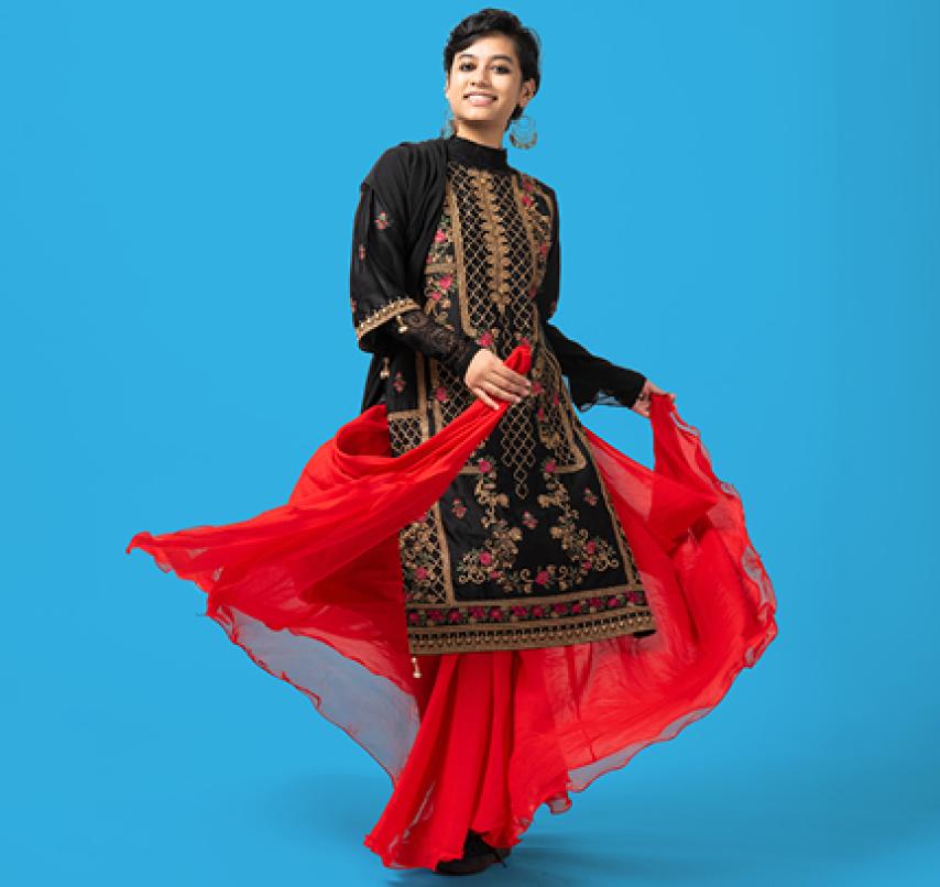 A community member smiles for the camera at a portrait session.