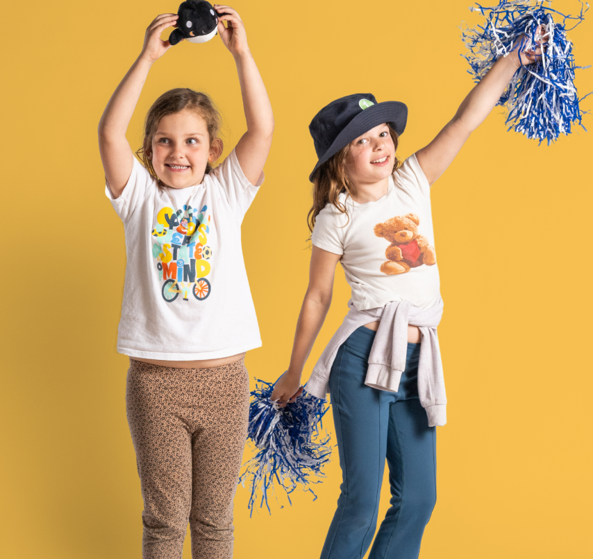Two kids dance with pom poms
