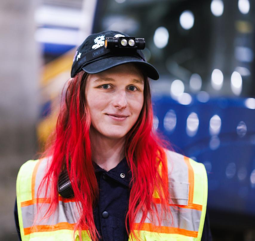 Sound Transit staff wearing yellow vest and hat.