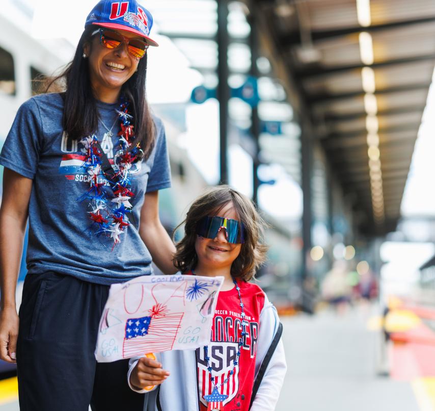 Fans of Team USA soccer standing on sounder platform